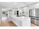 Modern kitchen featuring a large island, stainless steel appliances, and sleek white cabinetry at 211 E Muriel St, Orlando, FL 32806