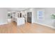 Bright and modern kitchen featuring a large island, stainless steel appliances, and wood floors at 211 E Muriel St, Orlando, FL 32806