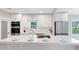 Modern kitchen with white cabinetry, stainless steel appliances, and a large center island at 211 E Muriel St, Orlando, FL 32806