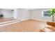 View of the living room showcasing the hardwood floors and steps up to another area of the home at 211 E Muriel St, Orlando, FL 32806