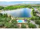 Aerial view of community pool and lake, surrounded by mature trees and walking trails at 2523 Water Valley Dr, St Cloud, FL 34771