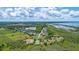 An aerial view capturing the community featuring a lake, pool, walking path and basketball and tennis courts at 2523 Water Valley Dr, St Cloud, FL 34771