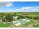 Aerial view of a basketball court, tennis court and vast green space creating a serene outdoor experience at 2523 Water Valley Dr, St Cloud, FL 34771