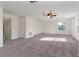 Spacious bonus room featuring neutral paint, plush carpet, a ceiling fan, and lots of natural light at 2523 Water Valley Dr, St Cloud, FL 34771