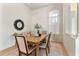 Bright dining room featuring a wooden table, upholstered chairs, and a decorative mirror at 2523 Water Valley Dr, St Cloud, FL 34771