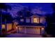 Charming two-story home with a two-car garage, and warm exterior lighting against a twilight sky at 2523 Water Valley Dr, St Cloud, FL 34771