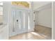 Bright foyer with tiled flooring, glass paneled door, and an open doorway to a carpeted room at 2523 Water Valley Dr, St Cloud, FL 34771