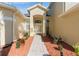 Inviting front entrance with a paver walkway, decorative plants, and a glass-paneled front door at 2523 Water Valley Dr, St Cloud, FL 34771