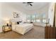 Bright main bedroom features a ceiling fan, neutral decor and large windows at 2523 Water Valley Dr, St Cloud, FL 34771