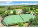 Overhead shot of a community tennis court and basketball court surrounded by landscaping at 2523 Water Valley Dr, St Cloud, FL 34771