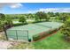 Fenced community tennis court with green surface and well-maintained landscaping at 2523 Water Valley Dr, St Cloud, FL 34771
