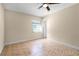Bedroom with tile floors, a window, and a ceiling fan at 2605 S Elm Ave, Sanford, FL 32773