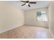 Bedroom with tile floors, a window, and a ceiling fan at 2605 S Elm Ave, Sanford, FL 32773