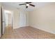 Bedroom features tile flooring, closet space, and a ceiling fan at 2605 S Elm Ave, Sanford, FL 32773