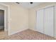 Neutral bedroom featuring tile floors and a large closet with white sliding doors at 2605 S Elm Ave, Sanford, FL 32773