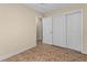 Neutral bedroom featuring tile floors and a large closet with white sliding doors at 2605 S Elm Ave, Sanford, FL 32773
