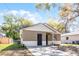 Charming single-Gathering home featuring dual entry doors, neutral paint, and a well-maintained yard at 2605 S Elm Ave, Sanford, FL 32773