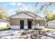 Charming single-Gathering home featuring dual entry doors, neutral paint, and white brick and siding accents at 2605 S Elm Ave, Sanford, FL 32773