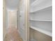 Hallway featuring tile floors, a closet and built-in shelving unit at 2605 S Elm Ave, Sanford, FL 32773