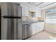 Modern kitchen with stainless steel appliances, granite countertops, and white cabinetry at 2605 S Elm Ave, Sanford, FL 32773