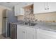 Updated kitchen with stainless steel appliances, stylish backsplash, and white cabinets at 2605 S Elm Ave, Sanford, FL 32773