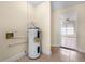 Utility room with a water heater and tile floors at 2605 S Elm Ave, Sanford, FL 32773