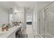 Bright bathroom featuring double vanity sinks, a shower, and a separate water closet at 2679 Metro Sevilla Dr # 101, Orlando, FL 32835