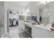 Bright bathroom with double sinks, a vanity area, and a walk-in closet and shower at 2679 Metro Sevilla Dr # 101, Orlando, FL 32835