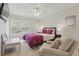 Inviting bedroom with a large window, cozy armchair, and neutral color palette at 2679 Metro Sevilla Dr # 101, Orlando, FL 32835