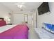 Bright bedroom with a ceiling fan, closet space, and a mounted television at 2679 Metro Sevilla Dr # 101, Orlando, FL 32835