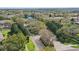 Aerial view of a well-maintained community with lush landscaping, pond, and mature trees at 2679 Metro Sevilla Dr # 101, Orlando, FL 32835