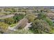 Scenic aerial view of a neighborhood featuring lush trees, landscaped entryways, and well-maintained roads at 2679 Metro Sevilla Dr # 101, Orlando, FL 32835