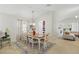 Cozy dining room features a wooden table with seating for six, an area rug, and an open layout at 2679 Metro Sevilla Dr # 101, Orlando, FL 32835