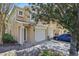 Inviting condo exterior showcasing attached garages and a well-manicured landscape, shaded by a large tree at 2679 Metro Sevilla Dr # 101, Orlando, FL 32835