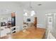 Open-concept kitchen and dining area featuring modern lighting, a dining table for six, and kitchen appliances at 2679 Metro Sevilla Dr # 101, Orlando, FL 32835