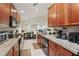 Well-lit kitchen with stainless steel appliances, tile floors and an adjacent dining area at 2679 Metro Sevilla Dr # 101, Orlando, FL 32835