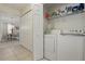Efficient laundry area with washer, dryer, and shelving for storage of supplies at 2679 Metro Sevilla Dr # 101, Orlando, FL 32835