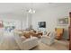 Bright living room with a comfortable sofa, accent chairs, and sliding glass doors leading to a balcony at 2679 Metro Sevilla Dr # 101, Orlando, FL 32835