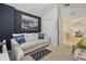 Comfortable living room with dark accent wall, plush seating, and ample natural light at 2679 Metro Sevilla Dr # 101, Orlando, FL 32835