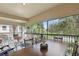 Inviting screened-in balcony with ample seating and views of lush landscape at 2679 Metro Sevilla Dr # 101, Orlando, FL 32835