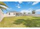 A expansive backyard with lush green grass and a screened in patio at 2951 Irish Peach Dr, Winter Garden, FL 34787