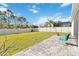 A large backyard with a white fence, grass and a paver patio at 2951 Irish Peach Dr, Winter Garden, FL 34787