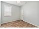 Clean bedroom with wood-look tile floors, a ceiling fan, and a bright window at 2951 Irish Peach Dr, Winter Garden, FL 34787