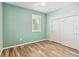 This bedroom features wood-look tile flooring and a window for natural light at 2951 Irish Peach Dr, Winter Garden, FL 34787