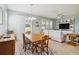 Open-concept dining area with wood table set, sliding glass doors, and views into the living room space at 2951 Irish Peach Dr, Winter Garden, FL 34787