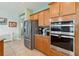 Close-up of modern stainless steel appliances in the kitchen, including refrigerator, oven, and granite countertops at 2951 Irish Peach Dr, Winter Garden, FL 34787