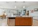 Kitchen island featuring granite countertops, wooden cabinets, a stainless steel sink, and pendant lighting above at 2951 Irish Peach Dr, Winter Garden, FL 34787