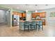 Spacious kitchen with wood cabinets, granite counters, stainless steel appliances and a center island with bar stool seating at 2951 Irish Peach Dr, Winter Garden, FL 34787