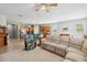 Open-concept living area with tile floors, a sectional sofa, kitchen view, and natural light at 2951 Irish Peach Dr, Winter Garden, FL 34787