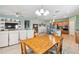 Open concept living space with dining area, kitchen with island, and comfortable seating, offering a seamless flow at 2951 Irish Peach Dr, Winter Garden, FL 34787